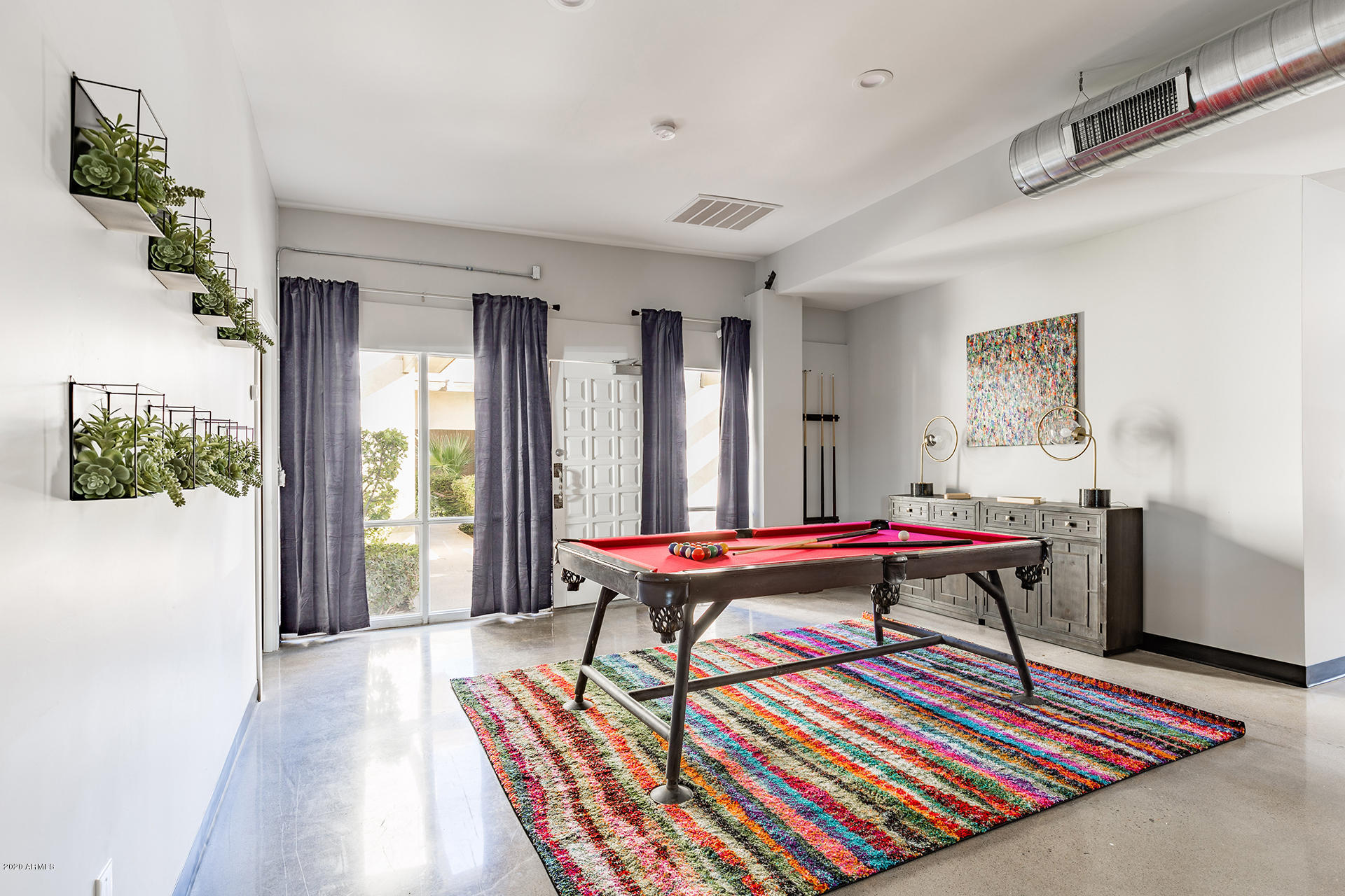 7505 East Main Street, Unit A Scottsdale, AZ 85251 - Photo 7 of 30 a living room with a rug a table and a potted plant