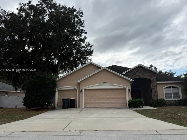 a view of a house with a yard and garage