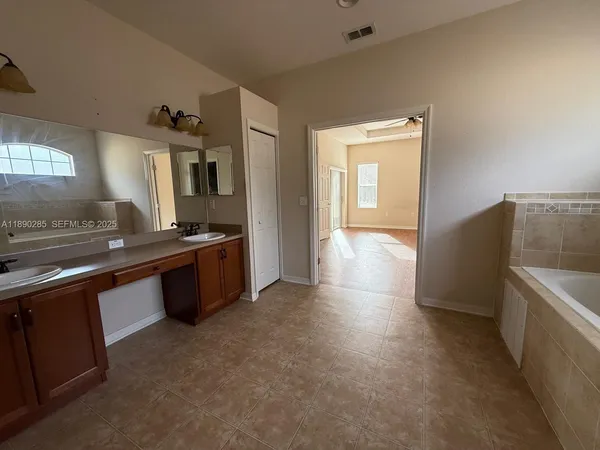 a view of a kitchen with a sink a stove and cabinets