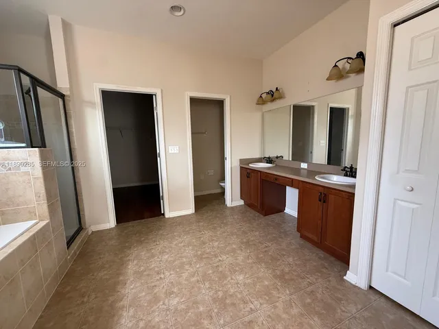 a view of kitchen with refrigerator and sink