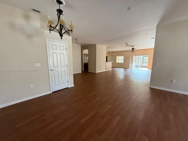 a view of a room with wooden floor and windows