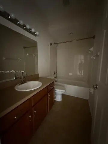 a bathroom with a sink a toilet a shower and mirror