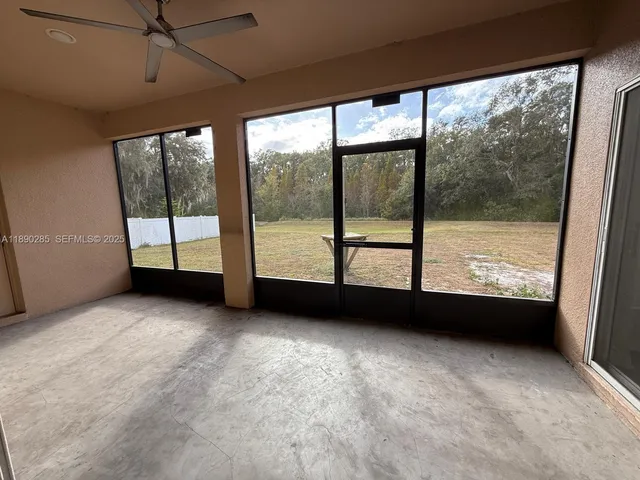 an empty room with large windows