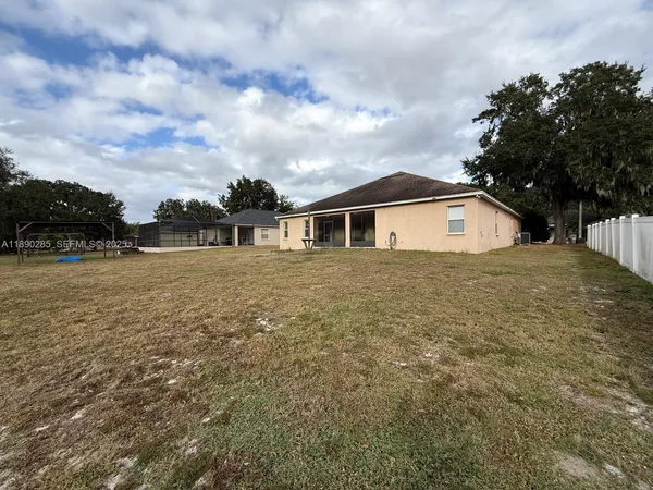 a view of house with yard and sitting area