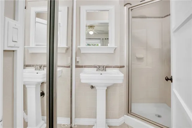 a bathroom with a sink a mirror and shower
