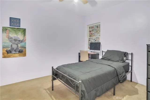 a bedroom with a bed and a painting on the wall