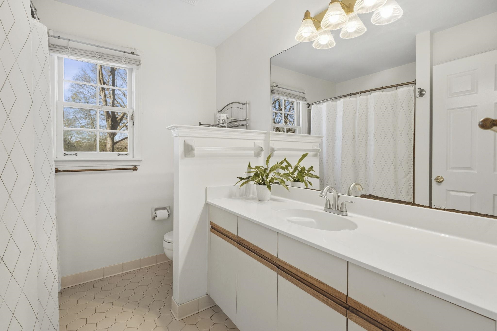 395 Alexander Street Memphis, TN 38111 - Photo 22 of 36 a bathroom with a sink a vanity and a mirror