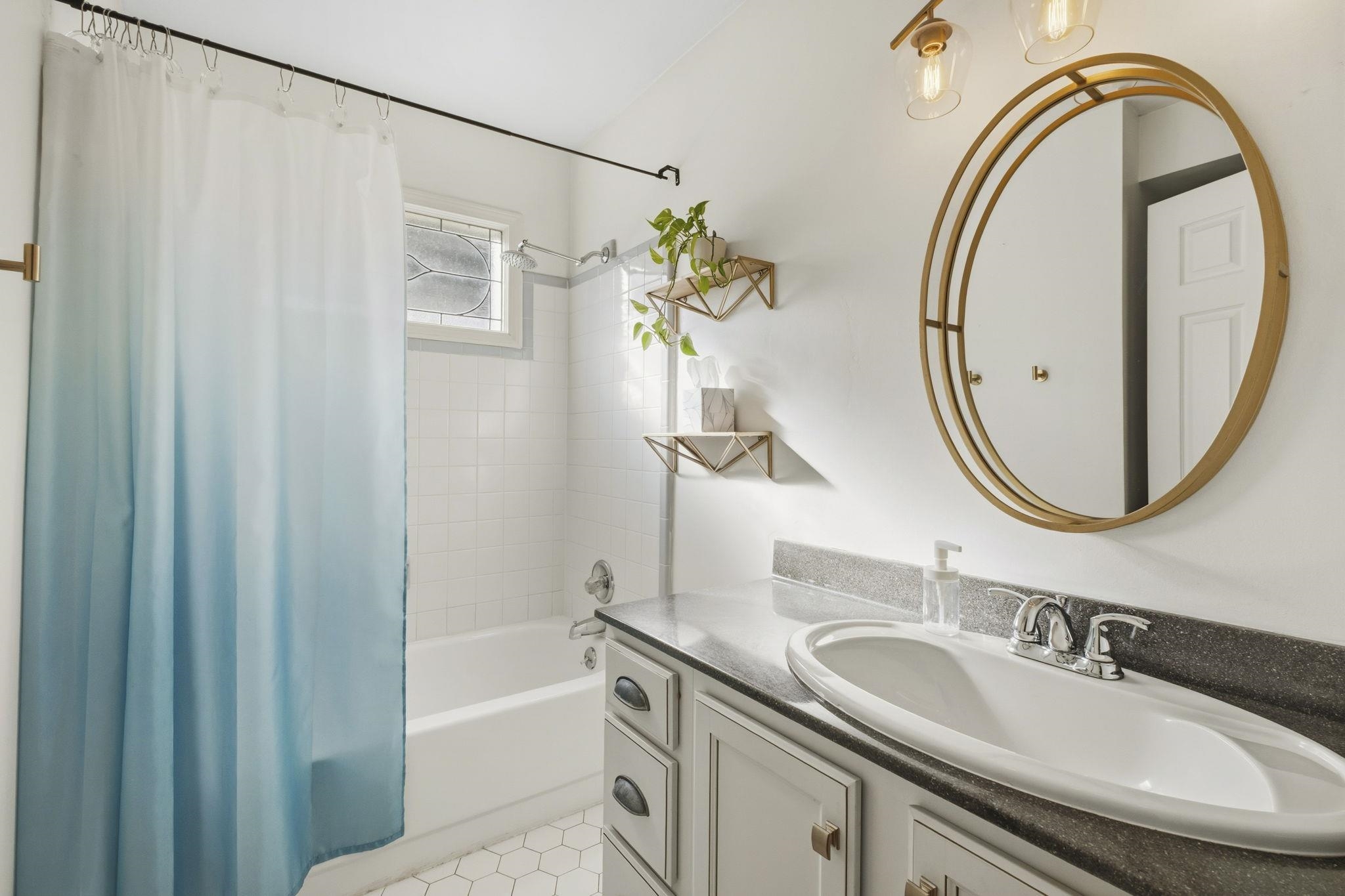395 Alexander Street Memphis, TN 38111 - Photo 24 of 36 a bathroom with a granite countertop sink a mirror and a shower