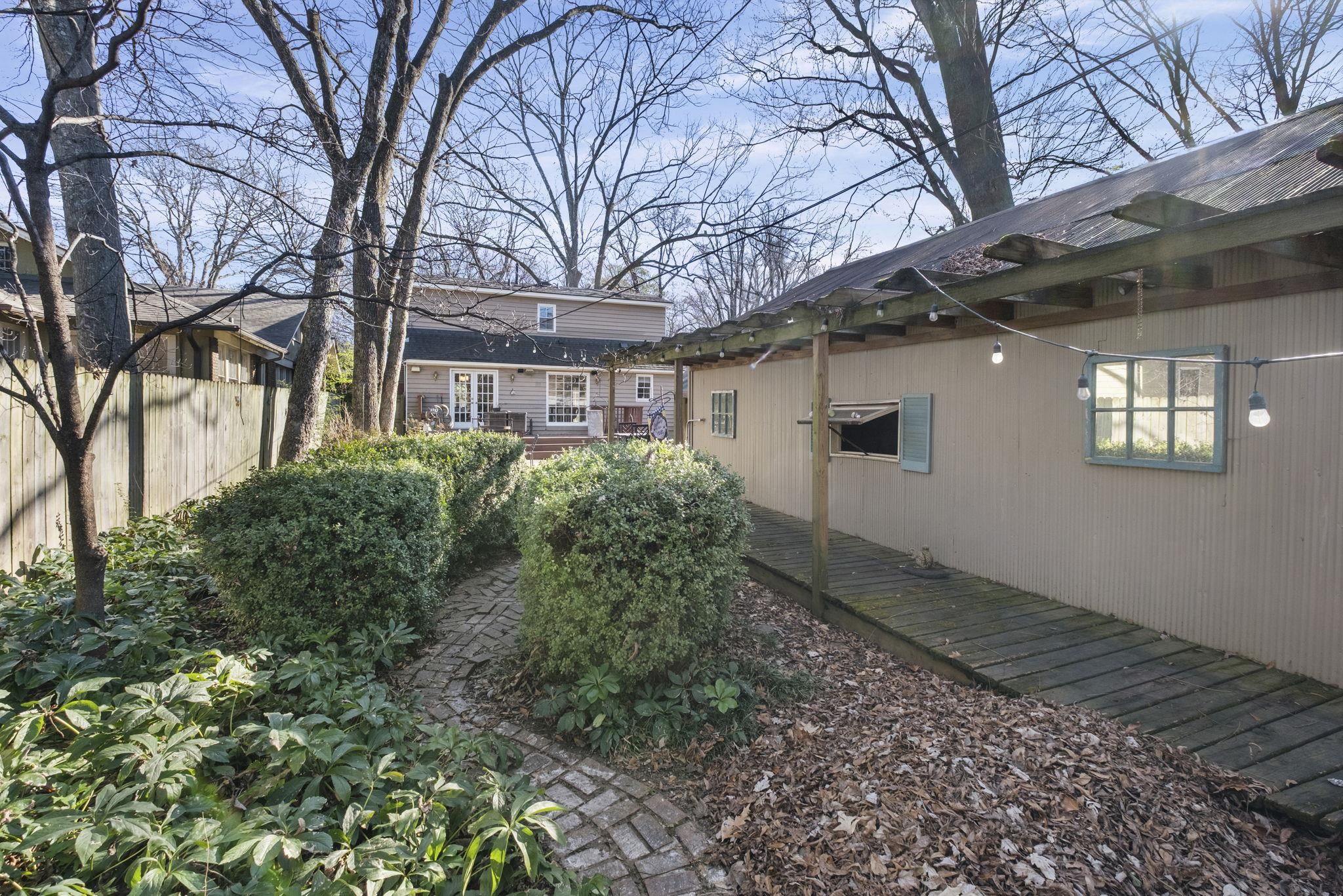395 Alexander Street Memphis, TN 38111 - Photo 29 of 36 a view of a house with a yard and potted plants