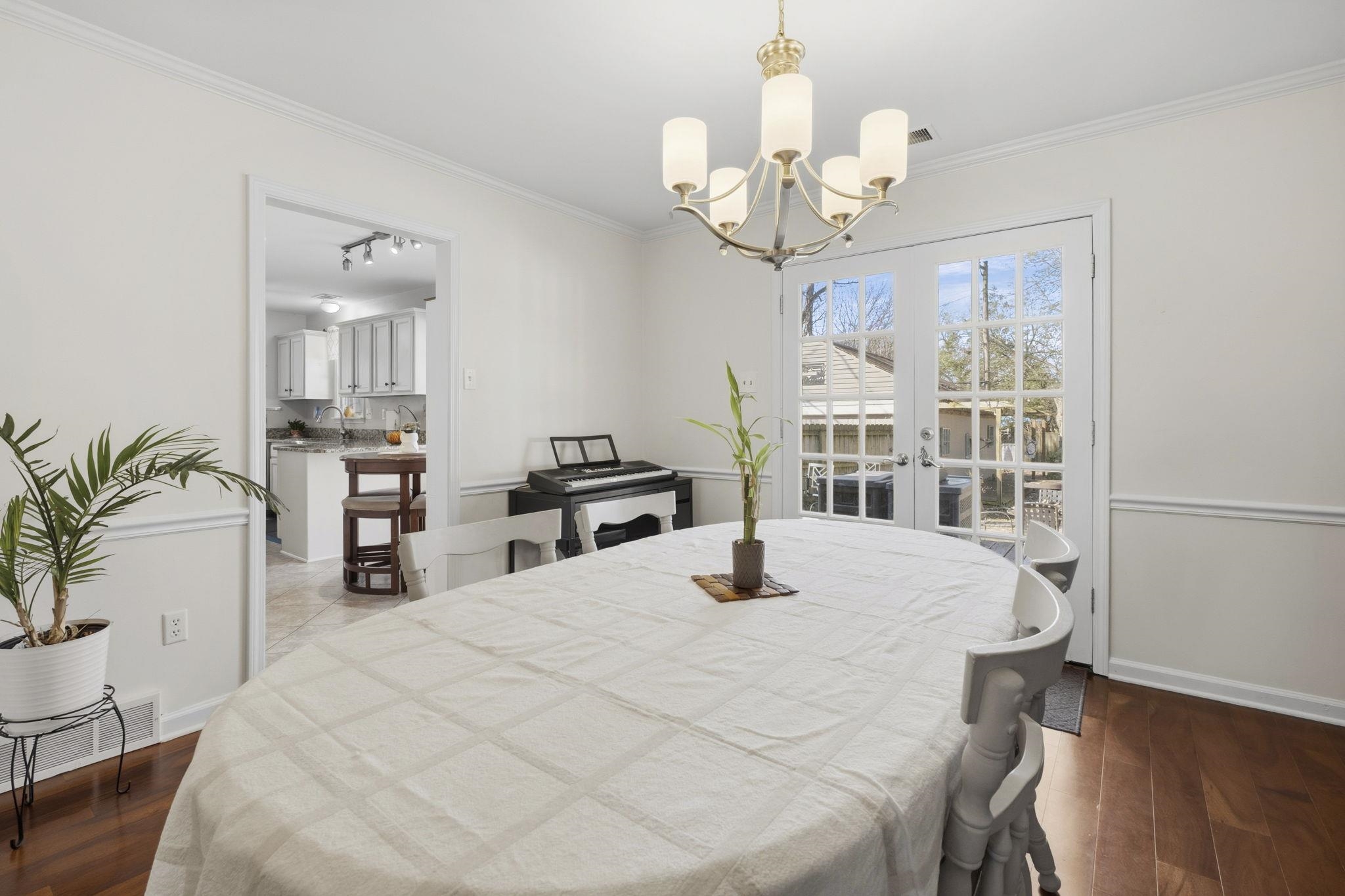 395 Alexander Street Memphis, TN 38111 - Photo 9 of 36 a bedroom with a large bed and a chandelier