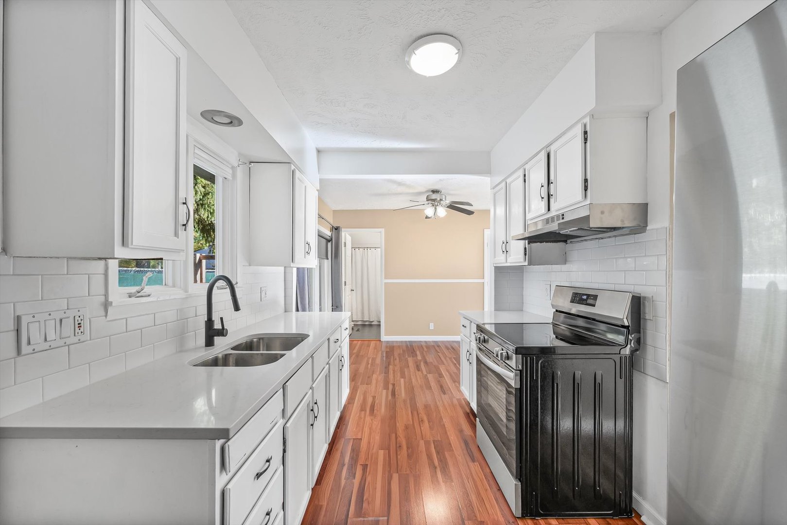606 Cullom Street Normal, IL 61761 - Photo 12 of 27 a kitchen with granite countertop a sink dishwasher stove and refrigerator