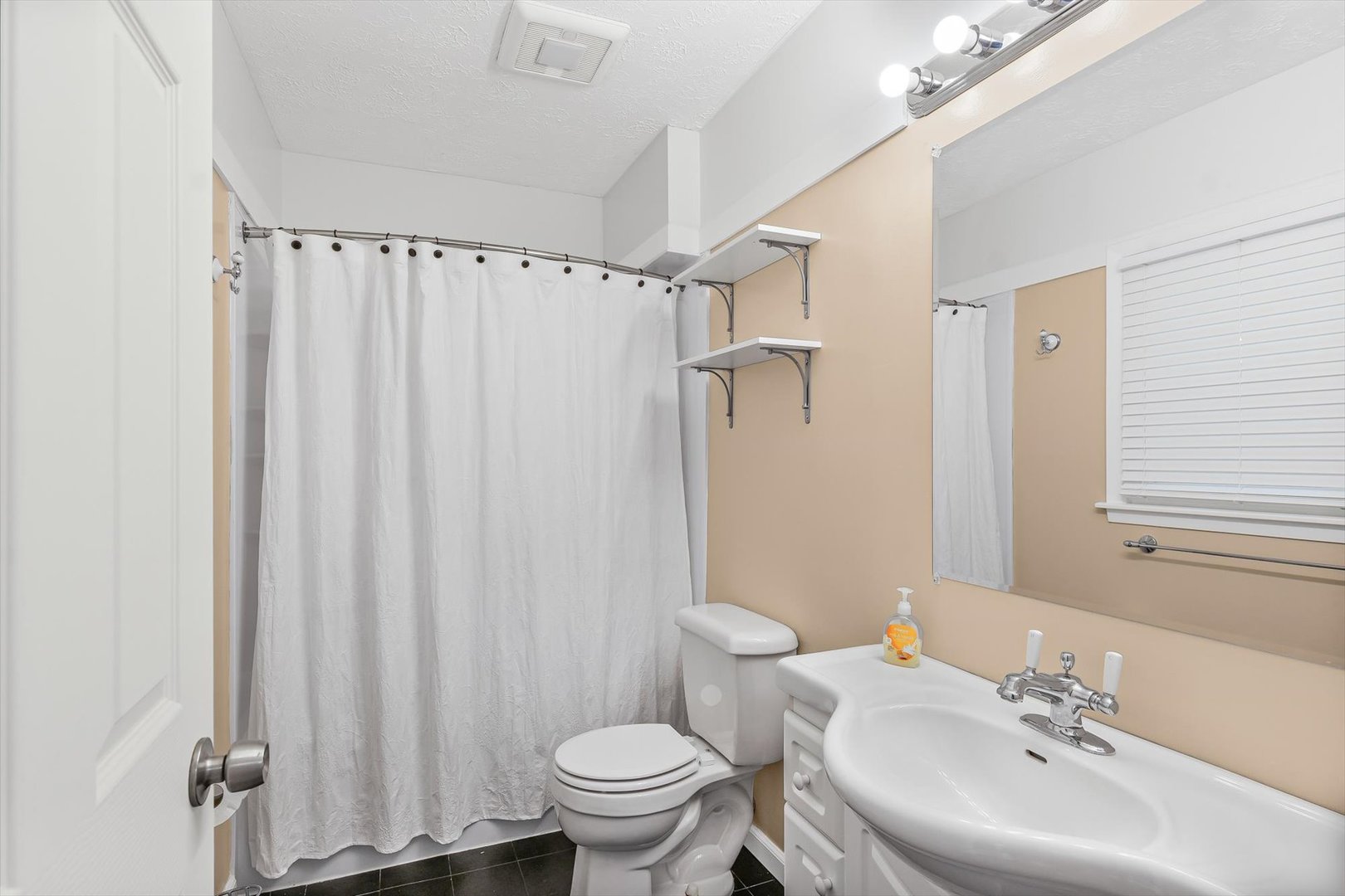 606 Cullom Street Normal, IL 61761 - Photo 17 of 27 a bathroom with a sink toilet and shower