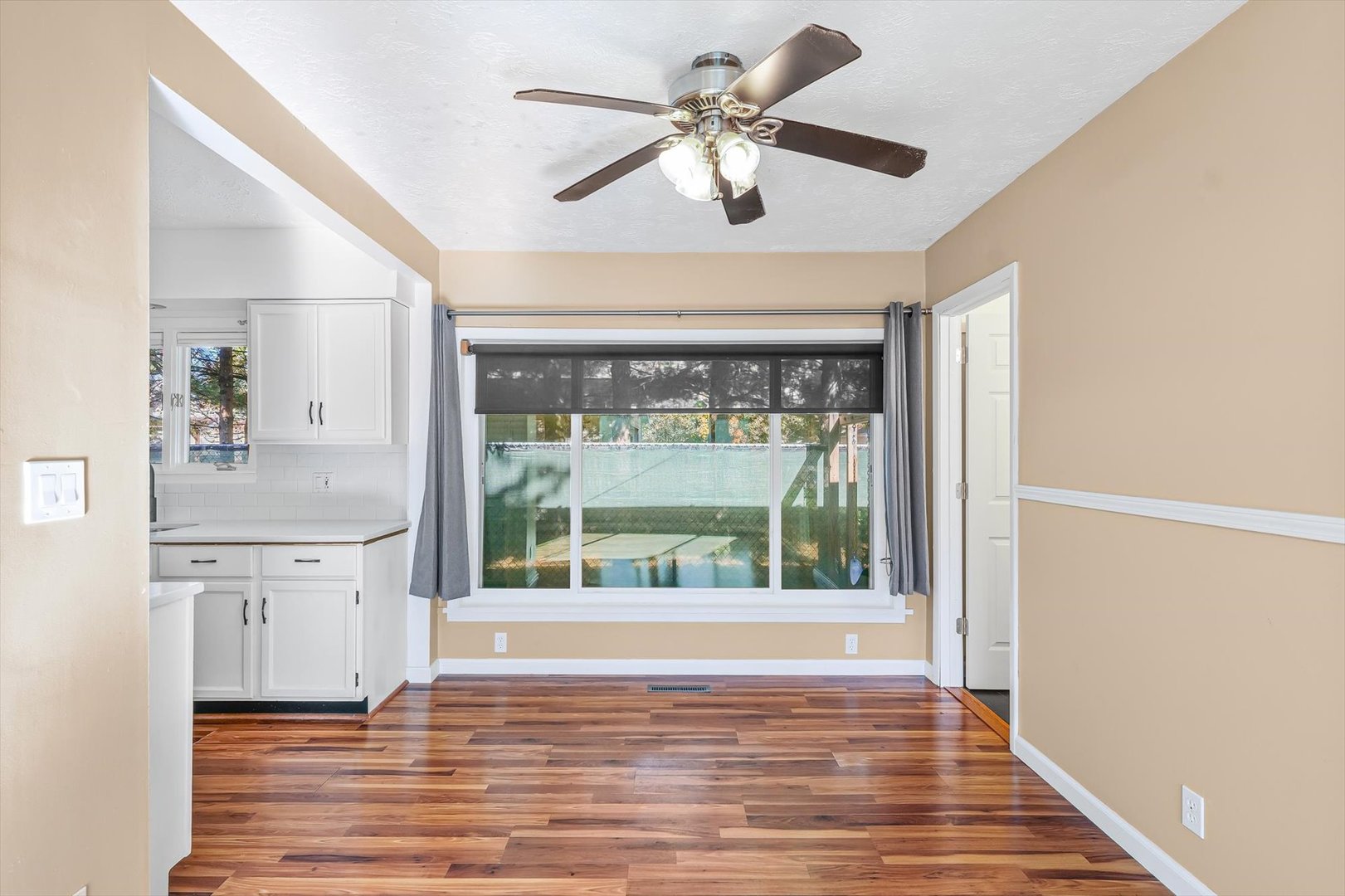 606 Cullom Street Normal, IL 61761 - Photo 8 of 27 a view of an empty room with a window and a kitchen view