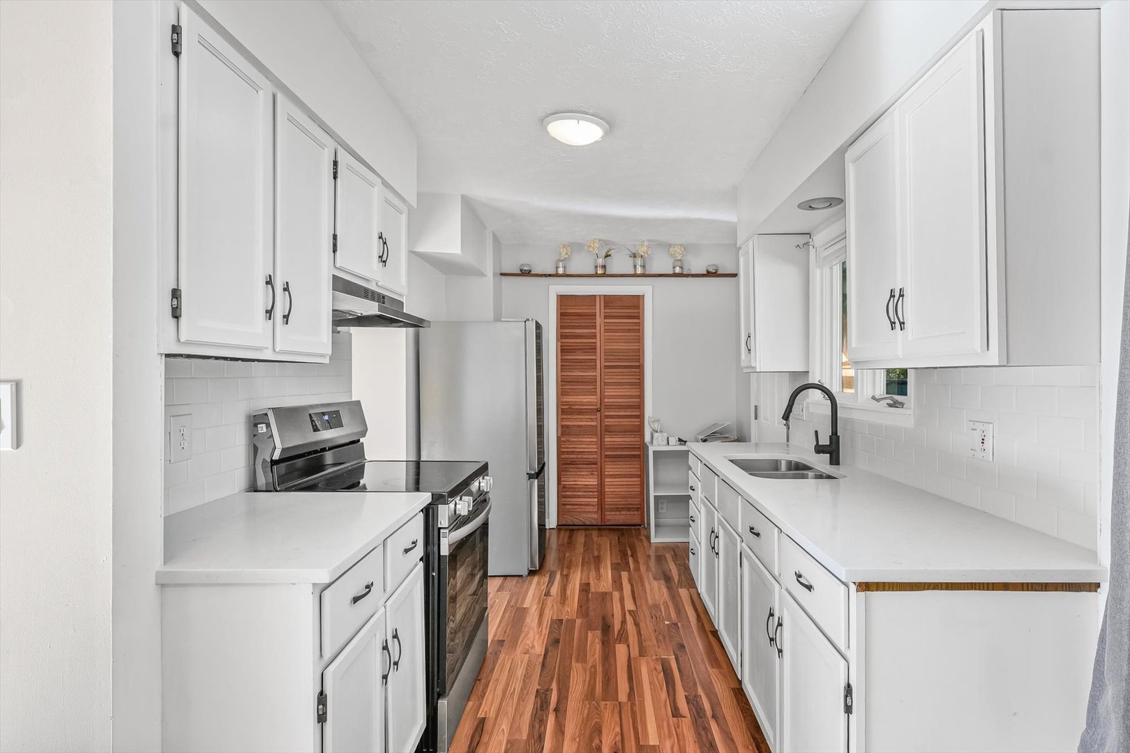 606 Cullom Street Normal, IL 61761 - Photo 10 of 27 a kitchen with white cabinets sink and stove