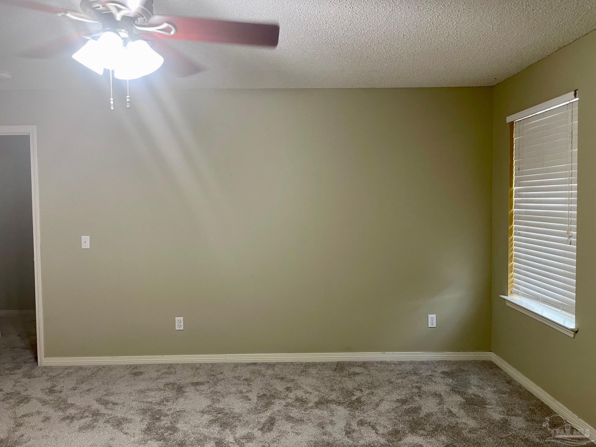 5162 Goshawk Drive Milton, FL 32570 - Photo 15 of 26 an empty room with windows and chandelier fan