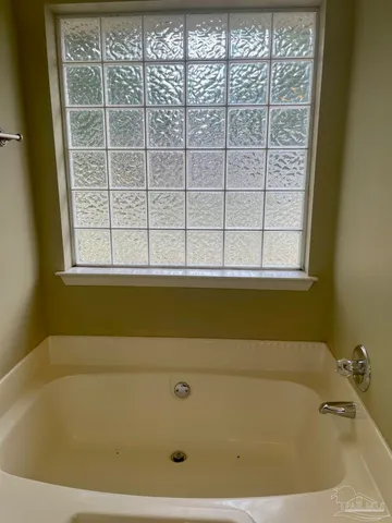 a white toilet sitting next to a white wall