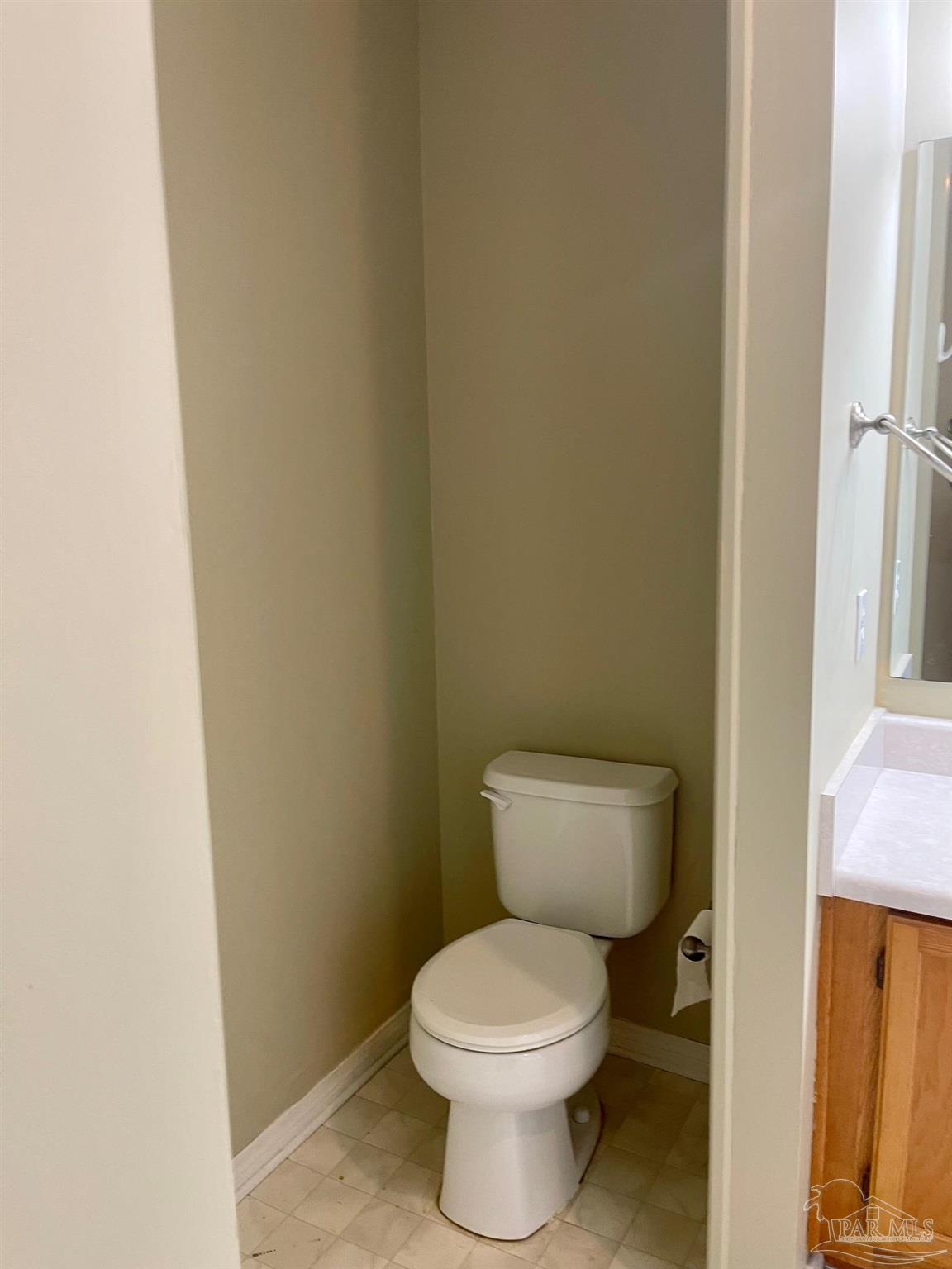 5162 Goshawk Drive Milton, FL 32570 - Photo 20 of 26 a white toilet sitting next to a white wall