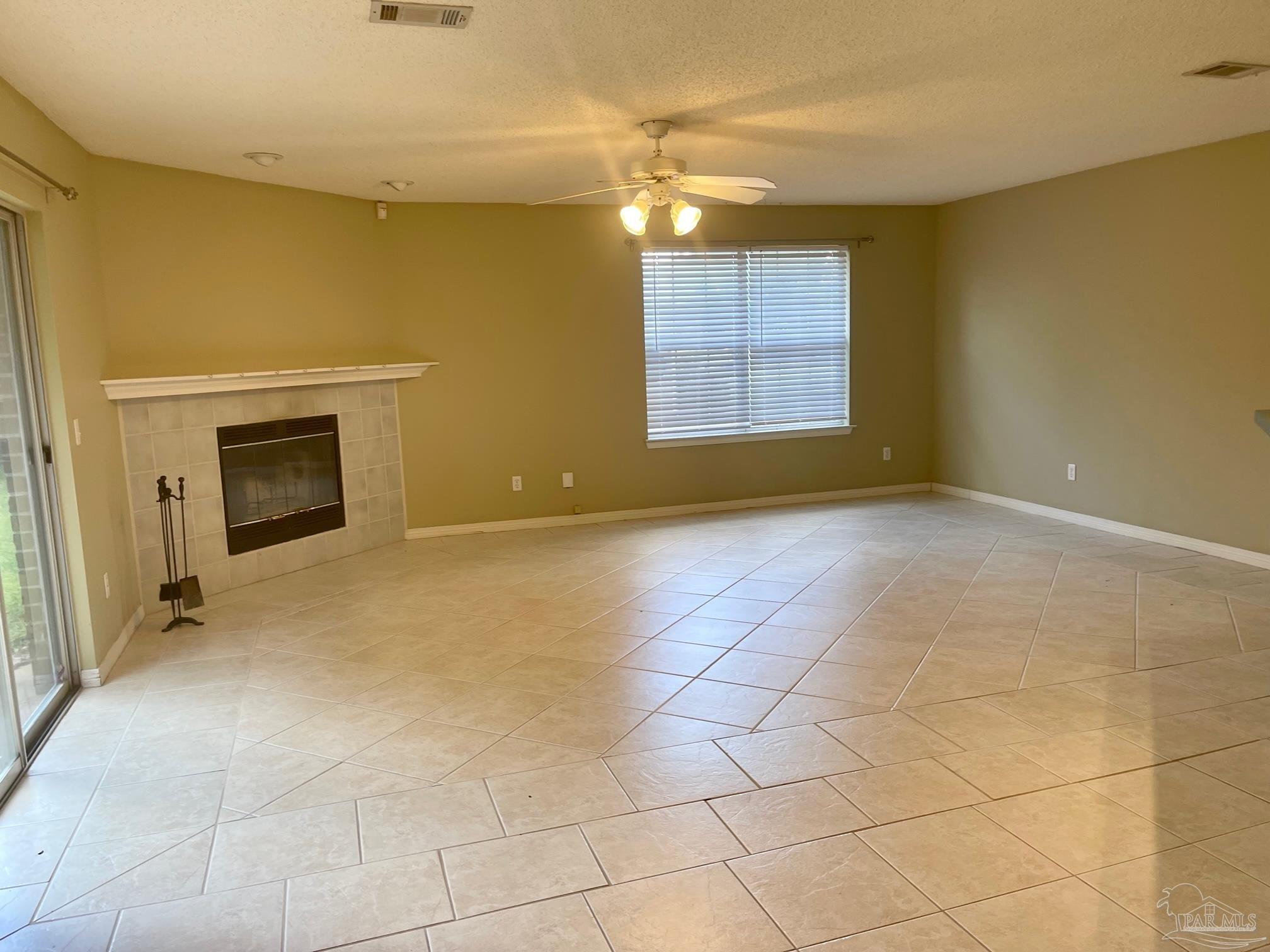 5162 Goshawk Drive Milton, FL 32570 - Photo 2 of 26 a view of empty room with a fireplace and window