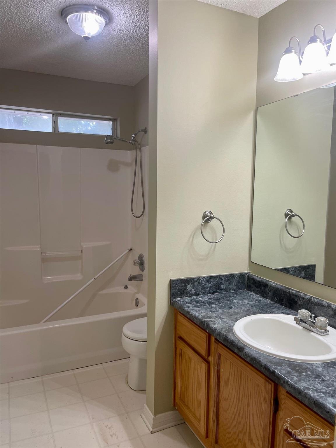 5162 Goshawk Drive Milton, FL 32570 - Photo 23 of 26 a bathroom with a granite countertop sink a toilet and shower