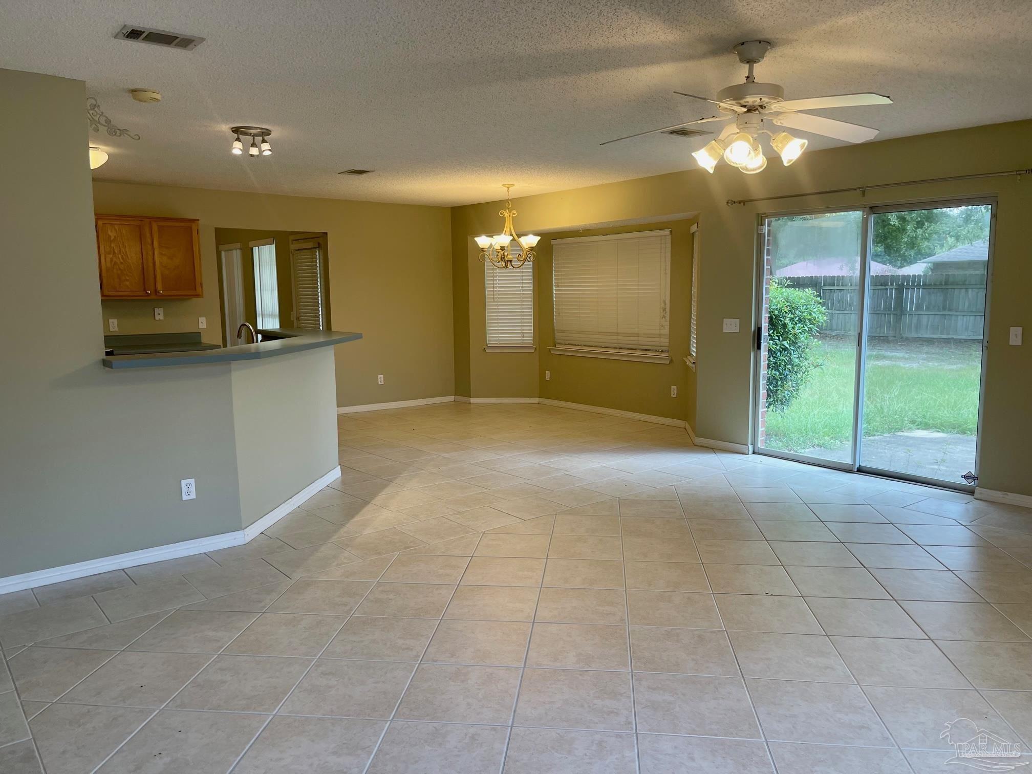 5162 Goshawk Drive Milton, FL 32570 - Photo 4 of 26 a view of a livingroom with a ceiling fan and window