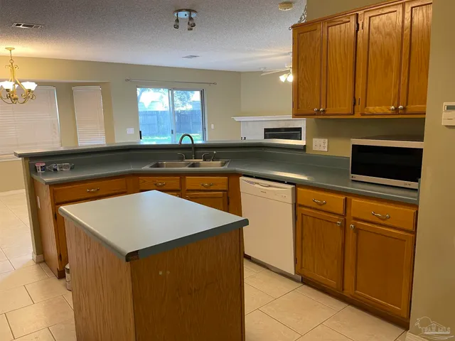 a kitchen with stainless steel appliances granite countertop a sink and a microwave