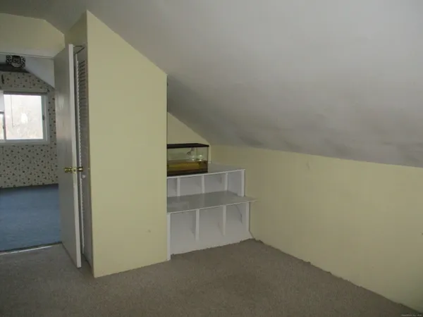 an empty room with a ceiling fan and window