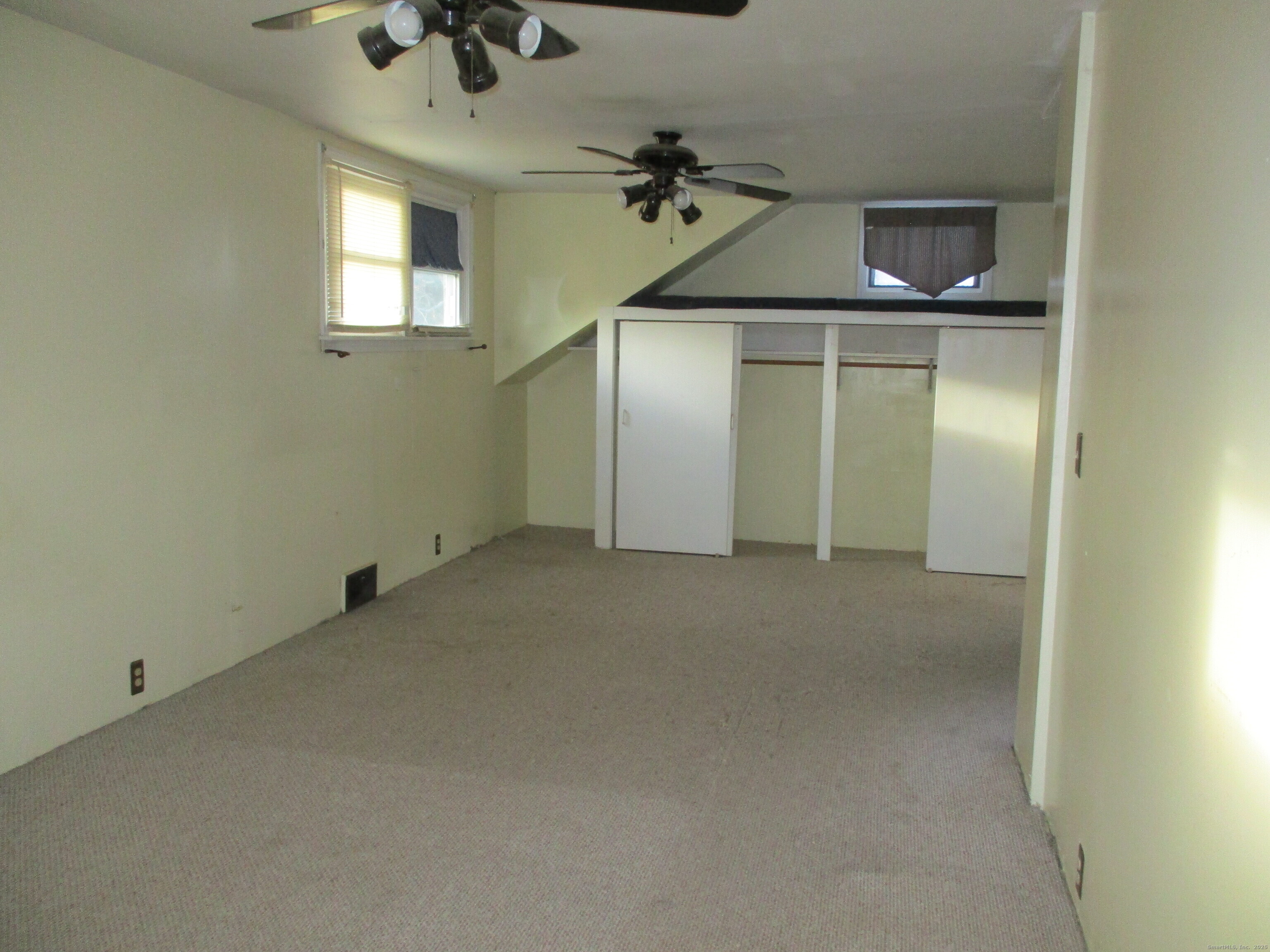 151 Brandy Hill Road Thompson, CT 06277 - Photo 14 of 36 an empty room with a ceiling fan and window