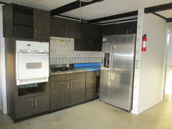 a kitchen with a refrigerator and a stove