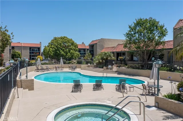 a view of a swimming pool with outdoor seating and plants