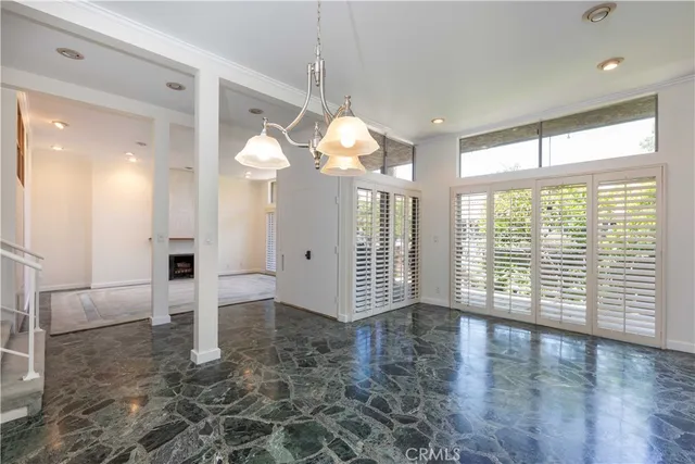 a view of a big room with wooden floor and windows