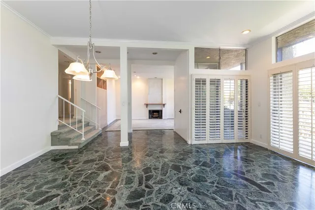 a view of empty room with a windows and fireplace