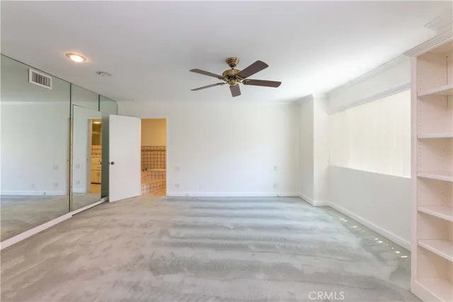 a view of a livingroom with a ceiling fan and window