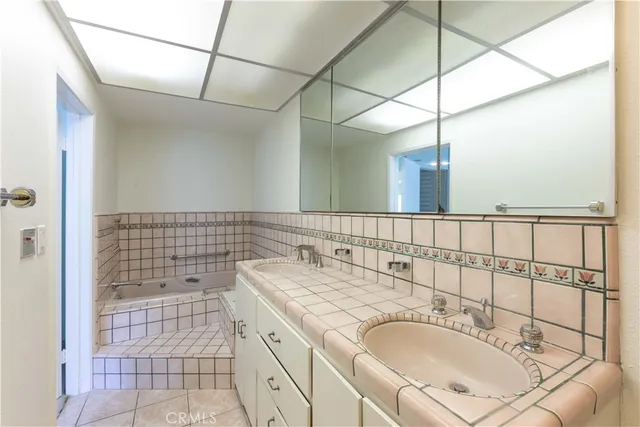 a bathroom with a sink double vanity and a shower