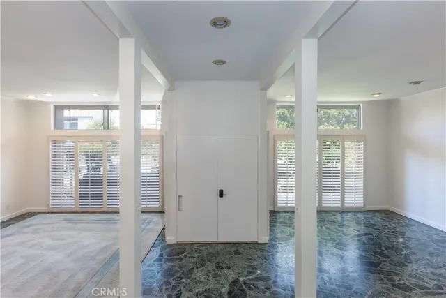 a view of an entryway with wooden floor and windows