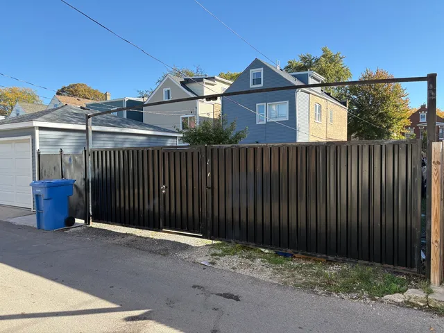a front view of a house with iron fence