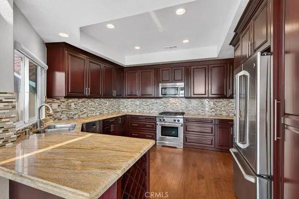 a view of a room with a chandelier and wooden floor