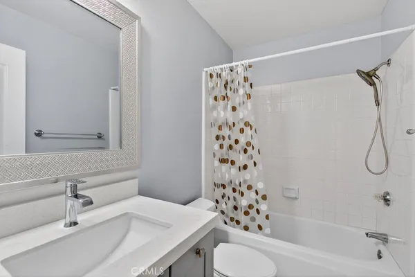 a bathroom with a white sink a toilet and shower