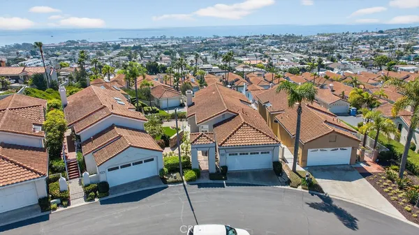 an aerial view of multiple houses with a yard