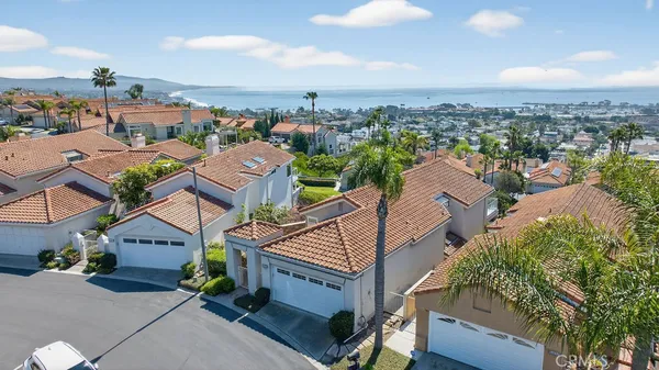 an aerial view of multiple houses with a big yard