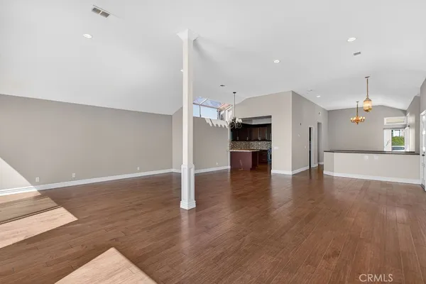 a kitchen with stainless steel appliances granite countertop wooden cabinets and a stove top oven