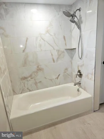 a bathroom with a bathtub and shower