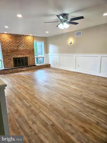 wooden floor in an empty room with a fireplace