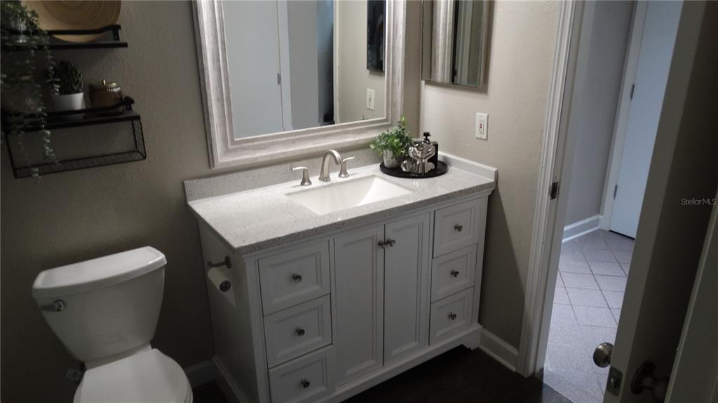 7240 Westpointe Boulevard, Unit 1125 Orlando, FL 32835 - Photo 16 of 33 a bathroom with a toilet sink and mirror
