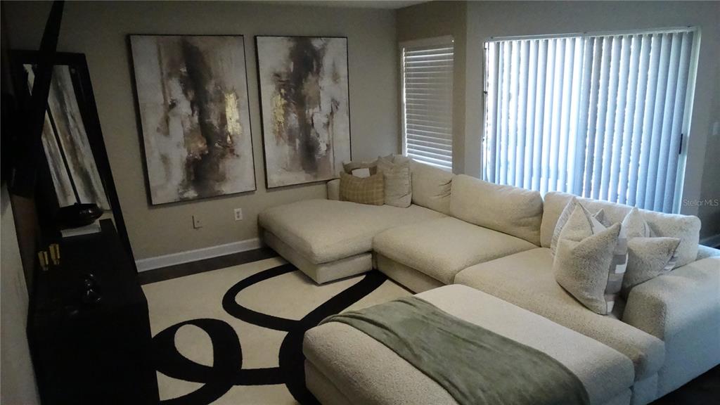 7240 Westpointe Boulevard, Unit 1125 Orlando, FL 32835 - Photo 24 of 33 a living room with furniture and a window