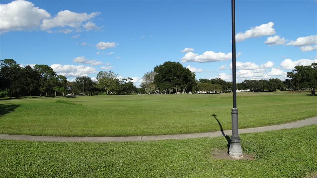 7240 Westpointe Boulevard, Unit 1125 Orlando, FL 32835 - Photo 27 of 33 a view of a golf course with a lake