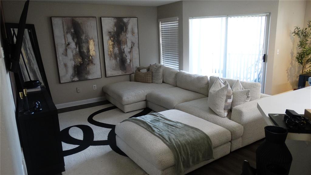 7240 Westpointe Boulevard, Unit 1125 Orlando, FL 32835 - Photo 33 of 33 a living room with furniture and a window