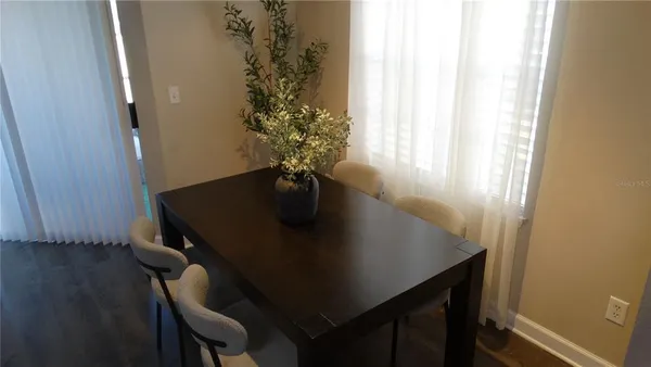 a view of a room with a table and chairs in it