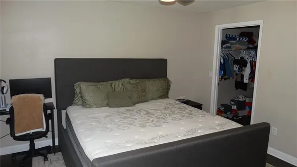 a bed sitting in a bedroom next to a window