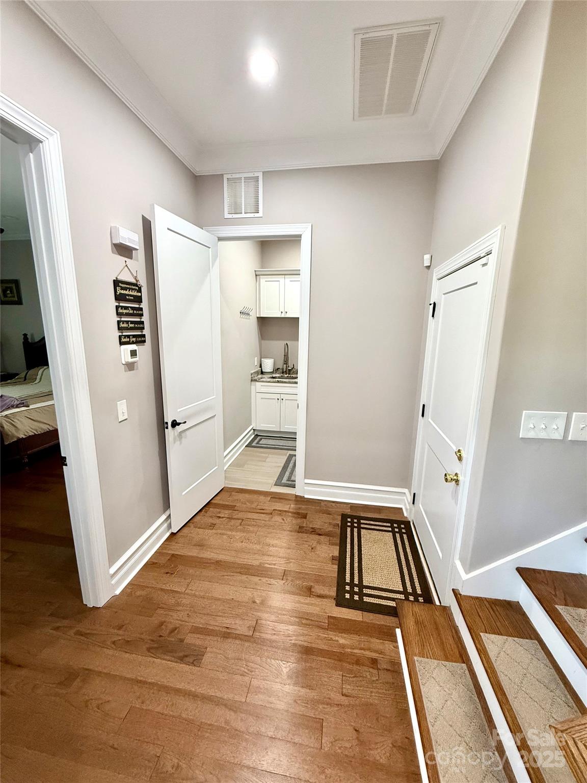 3508 Alfalfa Street Conover, NC 28613 - Photo 20 of 35 a view of a hallway with wooden floor and staircase