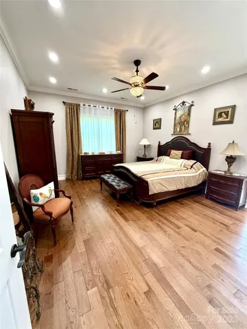 a bedroom with a bed couch and window